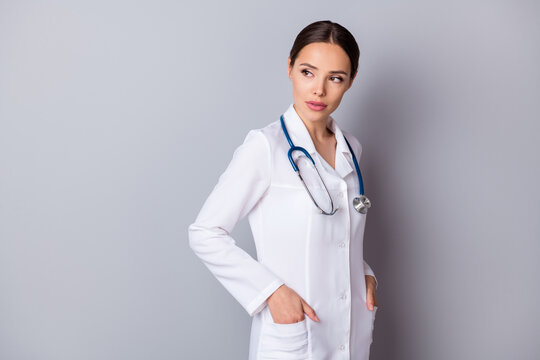 Profile photo of attractive family doc not smiling professional focused look empty space listen patient minded deep thinking ponder wear medical lab coat stethoscope isolated grey background