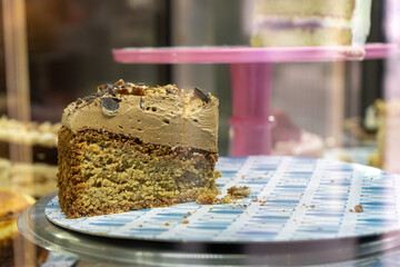 The last piece of biscuit cake with cream left on the cafe window
