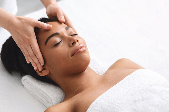 Black Lady Having Relaxing Head Massage At Spa Salon