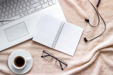 Home office concept. Laptop, notebook on blanket top view