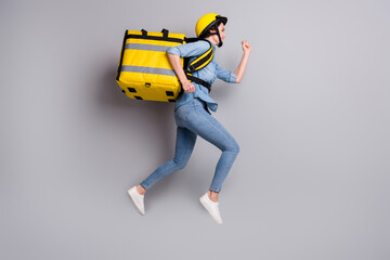 Full length profile side photo of girl courier jump run hurry deliver food home carry yellow...