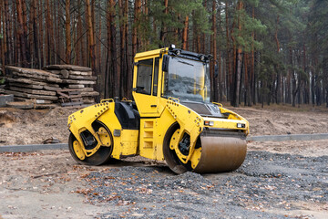Yellow bulldozer on the road