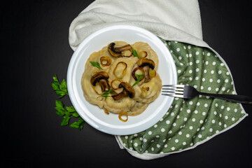 Dumplings with mushrooms, on a black background