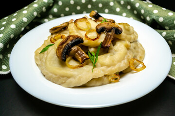 Dumplings with mushrooms, on a black background