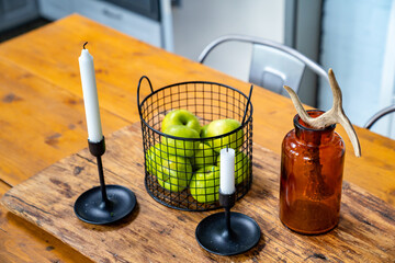 apples and candles a wooden table. kitchen in a Scandinavian style. 