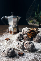 Fototapeta na wymiar A few marble brown cookies with star anise, cinnamon, coffee pot and powdered sugar