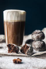 A few marble brown cookies with glass of coffee latte, star anise and powdered sugar