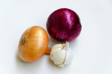 Group of whole ripe yellow onion, red onion and garlic on a white background, Sofia, Bulgaria  