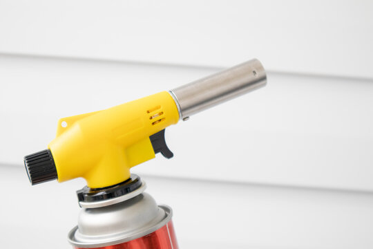 Manual gas torch burner on white background.