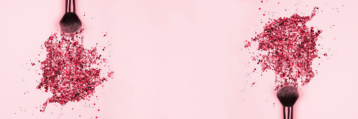 Banner with professional cosmetic makeup brushes with explosion of shiny pink colorful sparkles on...