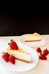 Close up of delicous cheesecake on white plates with organic home grown strawberries. Healthy food. Stay home. Cook home.  Happy father's day gift. Holidays. Celebration. Dessert