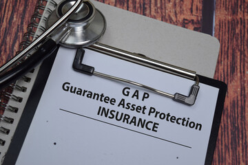 Book about GAP - Guarantee Asset Protection Law isolated on wooden table.