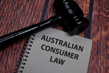 Australian Consumer Law write on paperwork isolated on wooden table.