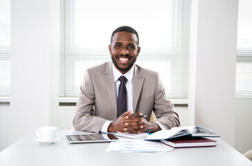 Fototapeta na wymiar Happy handsome african american businessman smiling while looking at camera in office