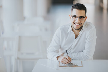 Smiling teacher in white shirt and glasses checking attendance
