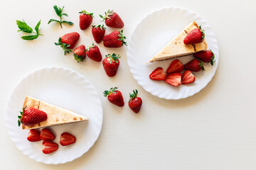 Strawberry and mint. Top view of tasty cheesecake and bio strawberries and mint leaves on white...
