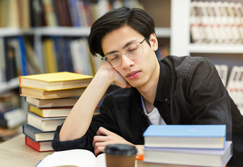 Tired student napping in the university library