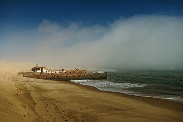 Shrouded in sea fog the Shawnee shipwreck on the Skeleton Coast of Namibia, south west Africa. © Gary