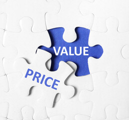 Puzzle with phrase PRICE VALUE on blue background, top view