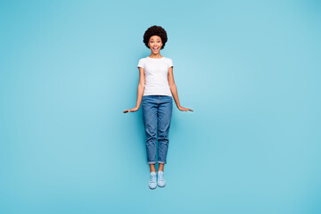 Full body photo of funny dark skin wavy lady jumping high amazing sunny summer day cheerful good...