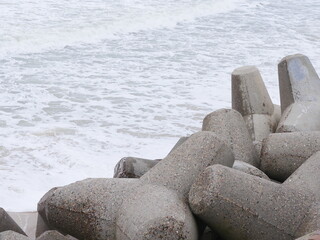Hacking with three teeth made of concrete, used for coastal protection as security against the...