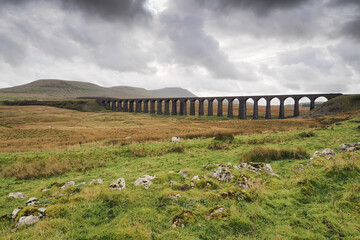Overcast moody sky above the iconic Ribblehead Viaduct or Batty Moss Viaduct which carries the Settle to Carlisle railway across Batty Moss in the Ribble Valley, Yorkshire Dales, UK