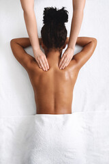 Neck massage for black lady lying down, view above