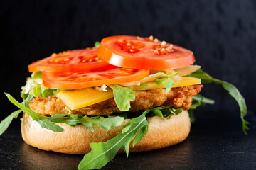 Open cheeseburger with arugula