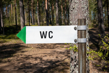 wc toilet sign in forest