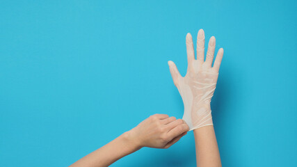 Right hand with white glove and left hand is pulling.Put on blue background.