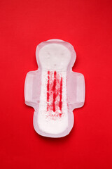 The menstrual cycle in women. Gasket on a red background. Vertical image