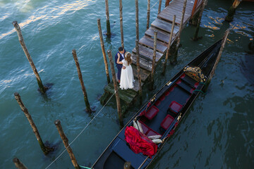 Beautiful wedding couple posing on dock in venice