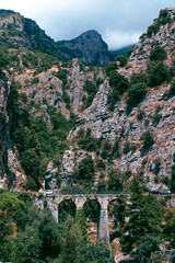 View of the old bridge made of stone. Between the steep mountains. Marina di Praia. Mountain landscape coast of Italy, Amalfi. Sea and rocks, Tourists and vacations in Europe