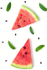 Pattern of slices of watermelon with seeds and mint leaves isolated on white background.