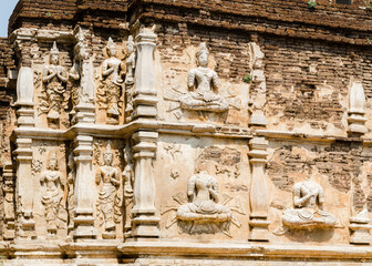 Old damaged stucco reliefs carvings of Buddha on the facade of Maha chedi, Wat Chet Yot, Chiang...