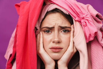 Photo of upset woman with clothes on her head looking at camera