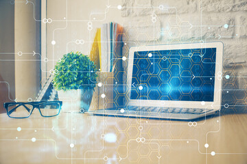 Double exposure of desktop computer and technology theme hologram. Concept of software development.