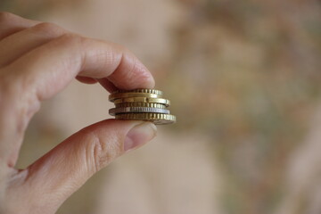 Coins in hand. Color toned image. Little money or small business concept