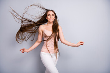 Photo of attractive lady demonstrating ideal neat long healthy hairstyle flying on air after salon...