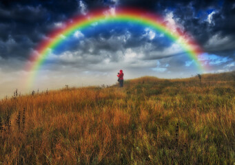
Woman Looking At Rainbow. At moment of wonderful