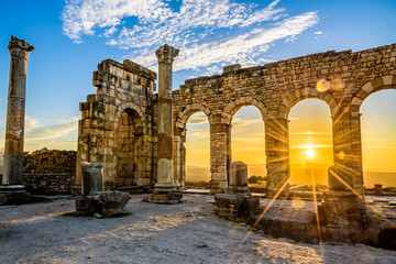 Volubilis is a partly excavated Berber city in Morocco situated near the city of Meknes, and commonly considered as the ancient capital of the kingdom of Mauretania. - obrazy, fototapety, plakaty