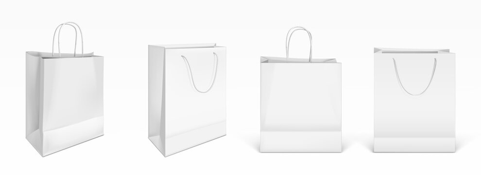 White paper shopping bags front and angle view. Vector realistic mockup of blank packet with handles isolated on white background. Template for corporate design on cardboard bag for store or market