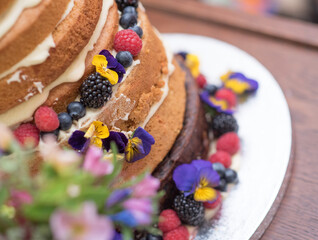Naked cake with pansies and fruit