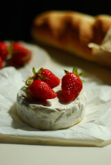 Fresh strawberries on Camembert cheese