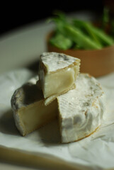 Fresh goat camembert and green pea pods