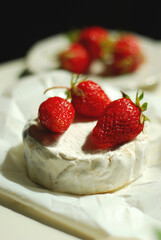 Fresh strawberries on Camembert cheese