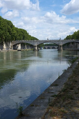 Fototapeta na wymiar Along the Tiber under the bridges of Rome