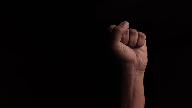 The concept against racism or racial discrimination by showing with hand gestures fist or solidarity in black background