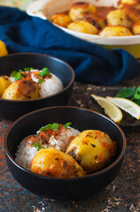 Baked potato stuffed with mince meat and rice with salad.