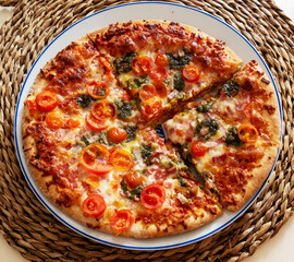 Sliced pizza on the white ceramic plate